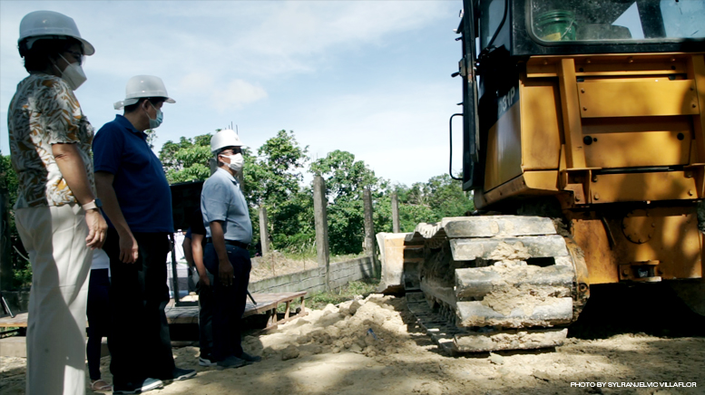 A bulldozer operates on the road opening of Liberty subdivision in Barangay Cararayan