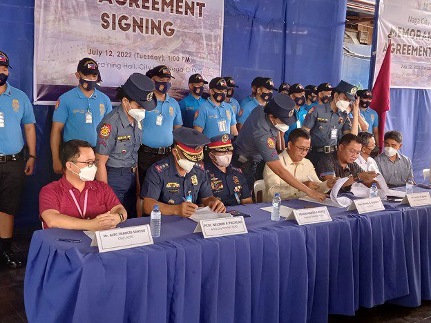 SIGNING Mayor Nelson Legacion (sitting, 4th from left) leads the signing of the memorandum of agreement by and between the Naga City Police Office, the Department of Tourism in Bicol, and LGU Naga. The Agreement seeks to further strengthen their partnership in ensuring the safety and security of local and foreign tourists through the Tourist-Oriented Police for Community Order and Protection (TOPCOP) program. Photo also shows DOT Regional Director Herbie Aguas (sitting, 3rd from right), NCPO chief Col. Nelson Pacalso, and ACTO head Alec Francis Santos (sitting, 2nd and 1st from left, respectively).