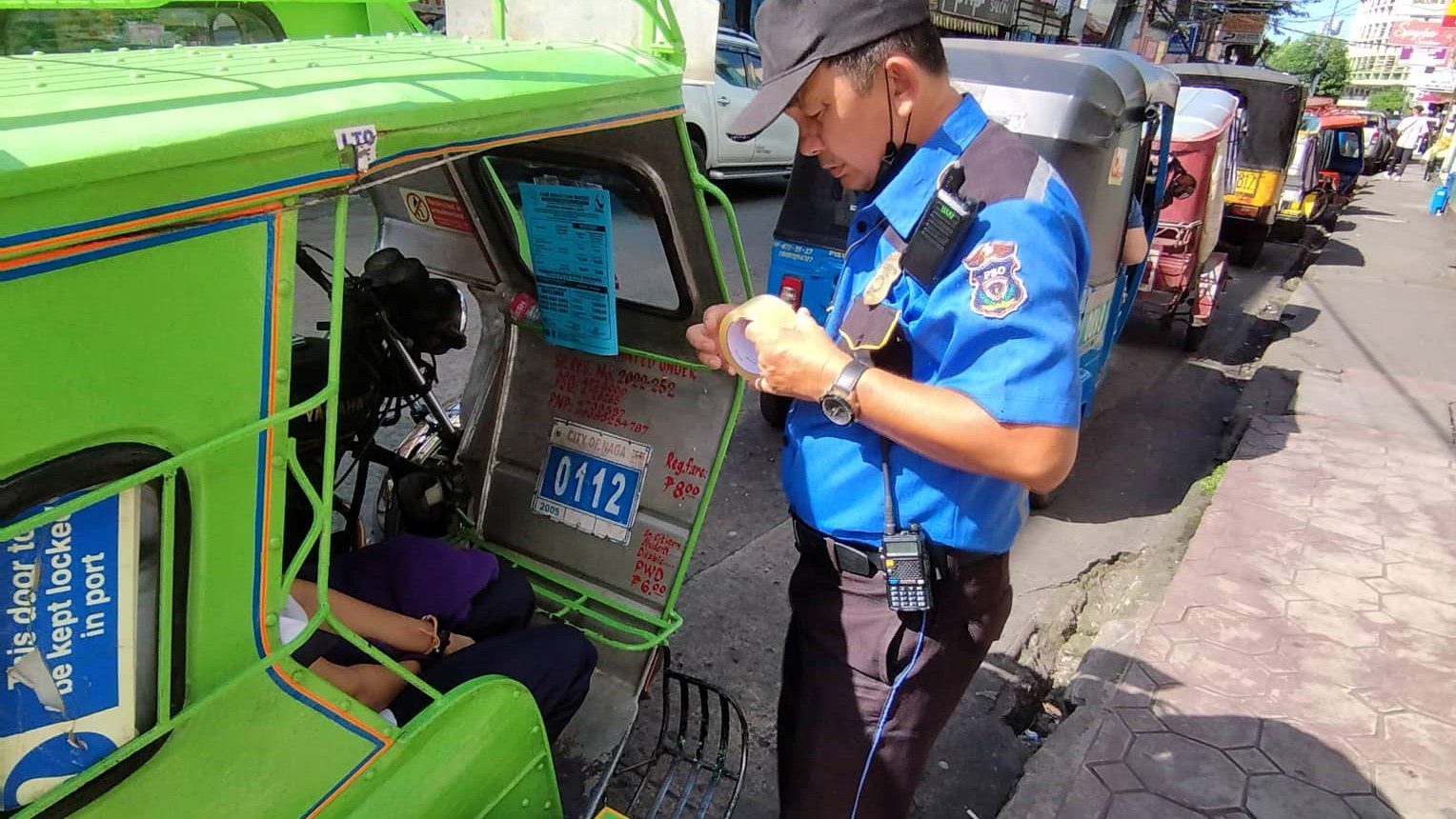 PSO Personnel facilitating the distribution and posting of fare matrix among trimobile operators and drivers.