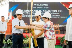 TIME CAPSULE President Marcos Jr. is being assisted by Mayor Nelson Legacion and Vice Mayor Cecilia de Asis in inserting a newspaper inside the time capsule which was used in the ground breaking ceremony on March 16, 2023, at the Balatas New Development Area where 7 medium or high-rise condominiums are to be constructed.