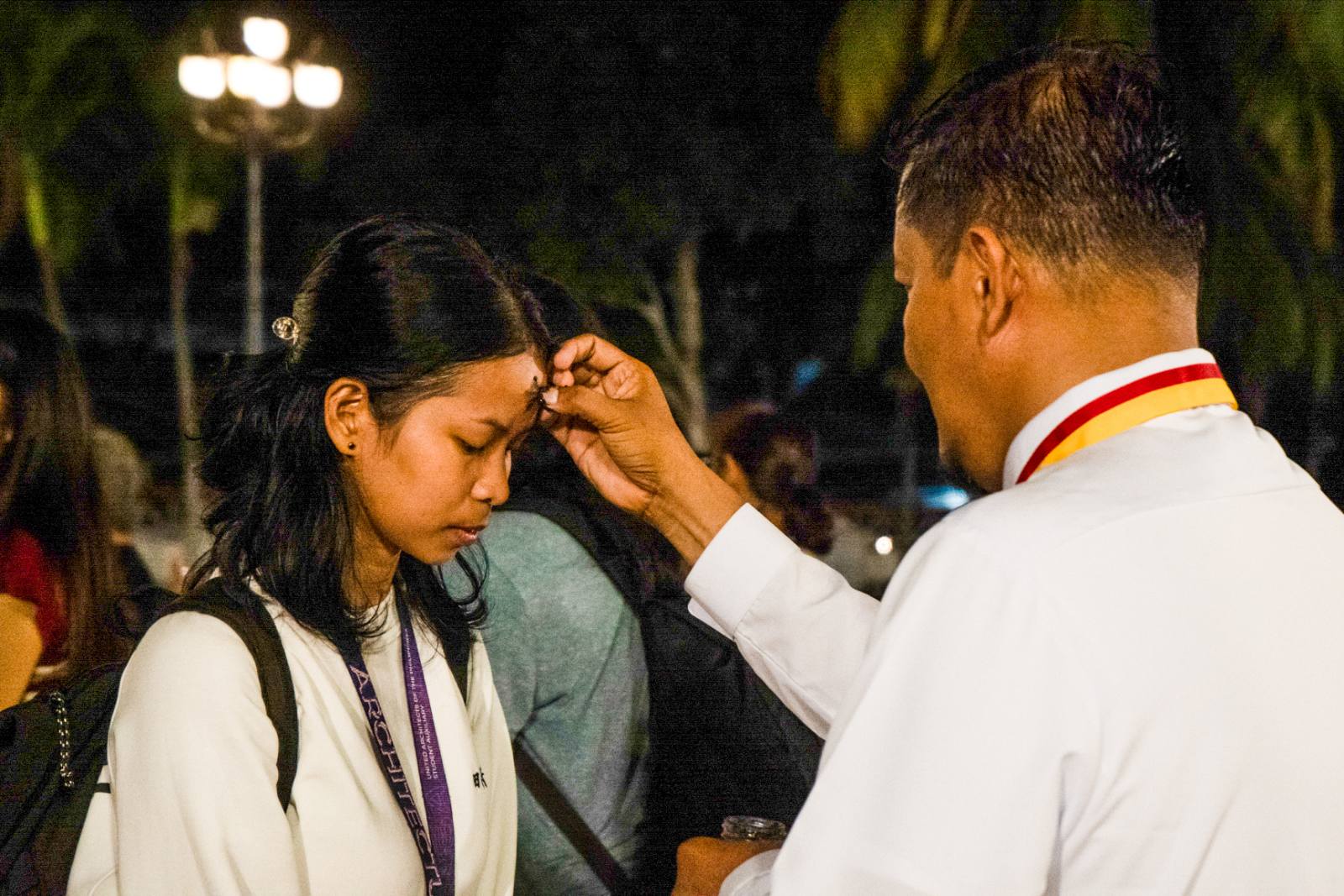 Imposition of Cross to a devotee after the Eucharistic Celebration at The Naga Metropolitan Cathedral.